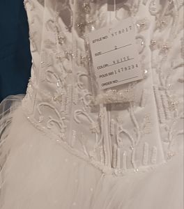 Size 2 brand new never worn white gown strapless with tulle and beading.